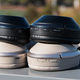 There’s the older MDR-1000X with three buttons on top and the new WH-1000XM2 on bottom with two. You can also see the different ear cup materials with the two models next to each other